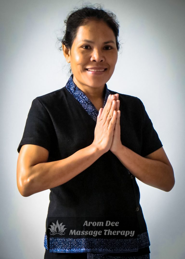 Thai Wai Massage Therapist with the palms pressed together in a prayer-like fashion wearing traditional Thai masseuse uniform